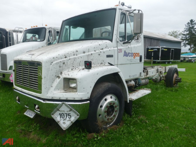 Freightliner FL70 chassis cab showing front grille and sidelabels with Avacogas logo and diamond plow marker.