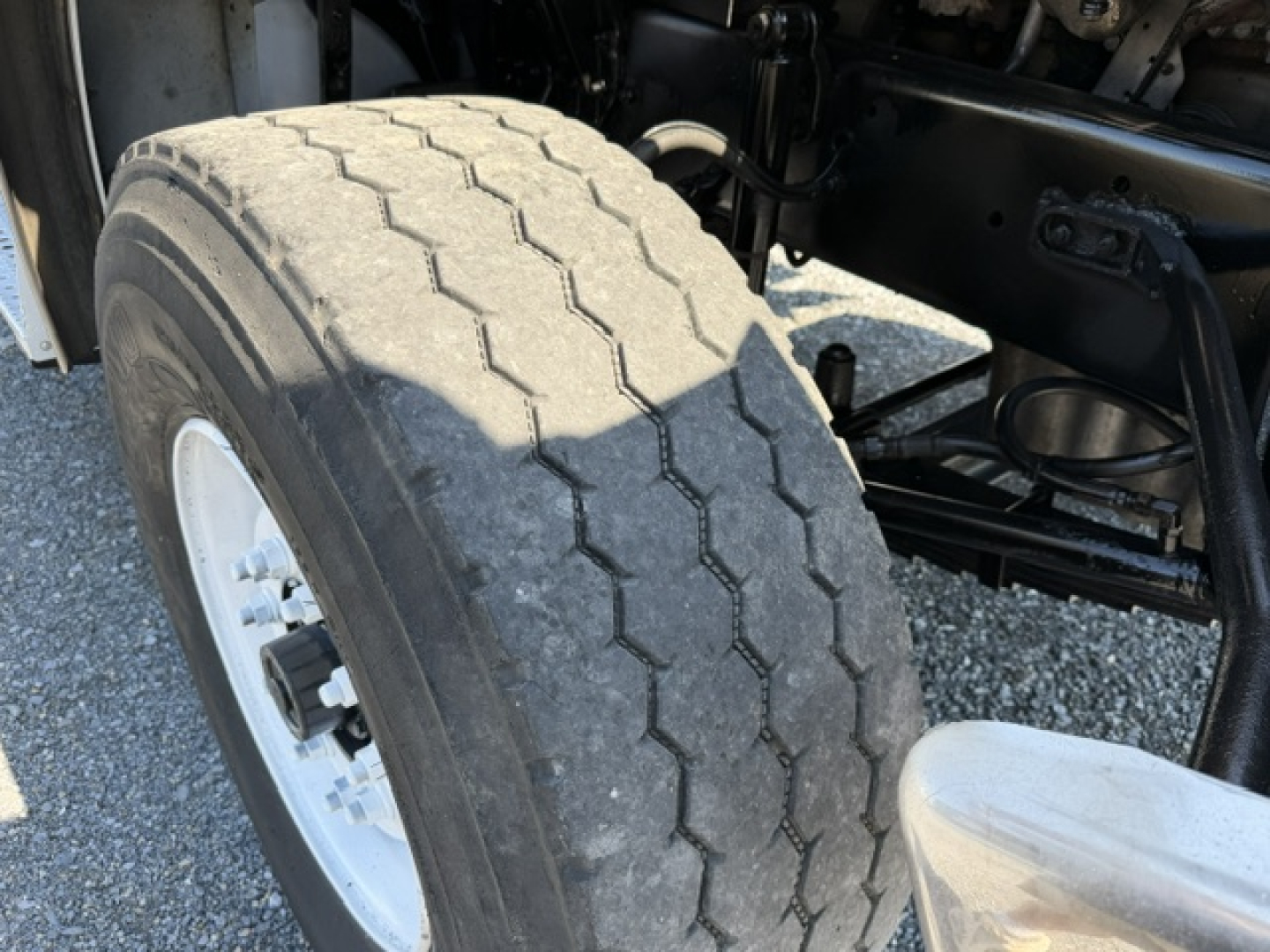 2006 Sterling LT9500 front wheel and suspension showing heavy-duty tire tread, wheel rim, and part of chassis and fender.