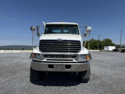 Front view of a white 2006 Sterling LT9500 flatbed truck with large grille and chrome bumper.
