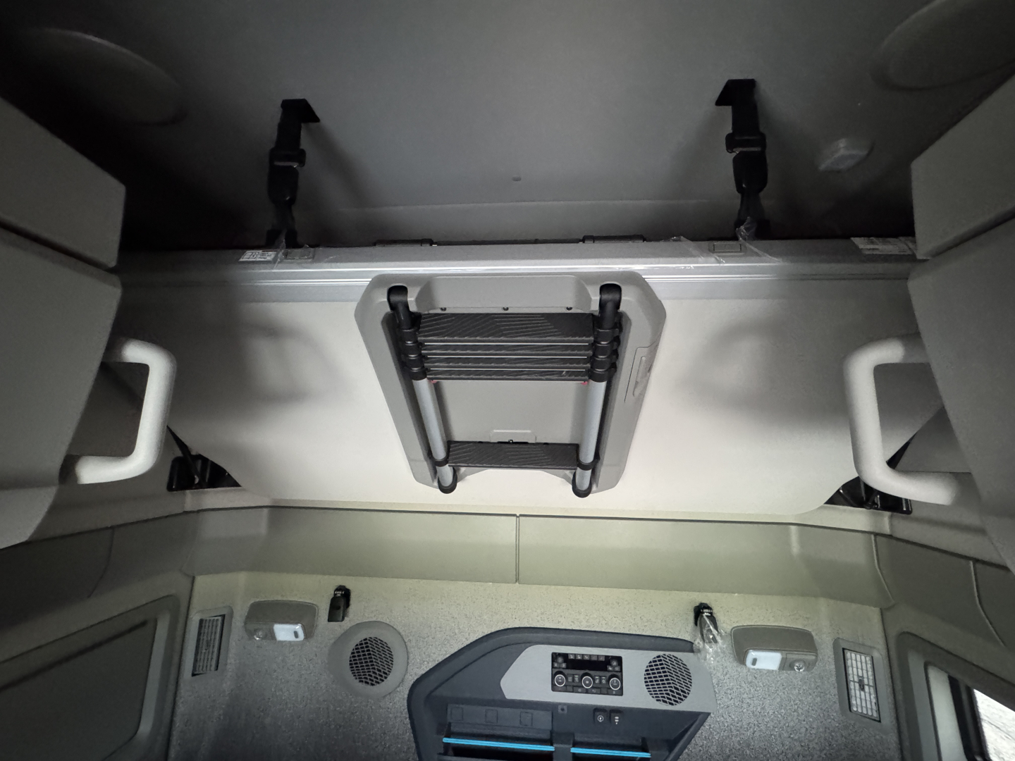 Volvo VNL64T860 cab interior showing overhead storage hatch and ceiling panels.