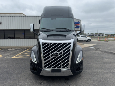 Volvo VNL64T860 truck front grille with large chrome grille, Volvo emblem, LED headlights, and black bumper.