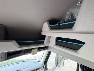 Interior overhead sleeper area of a Volvo VNL truck showing storage compartments and light gray panels.