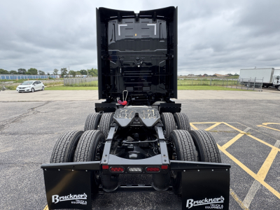 Volvo VNL64T860 truck chassis rear view with fifth wheel, dual rear axles, and mud flaps showing Bruckner’s branding; rear cab area and clean undercarriage visible.