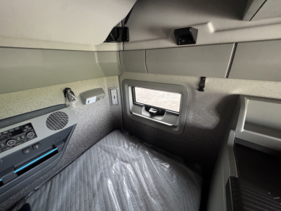 Volvo VNL64T860 sleeper cab interior showing window, storage pocket, and control panel.