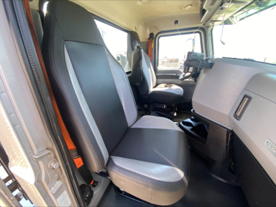 Mack PI64T interior cab view showing front seats and dashboard in a day cab truck.