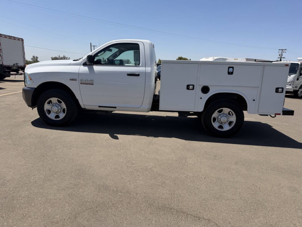 Ram 2500 service body truck side view showing white utility bed and crew cab with stock number 7911.