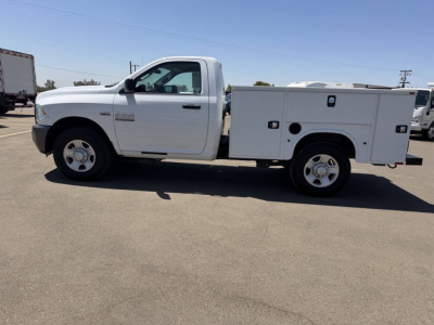 Ram 2500 service body truck side view showing white utility bed and crew cab with stock number 7911.