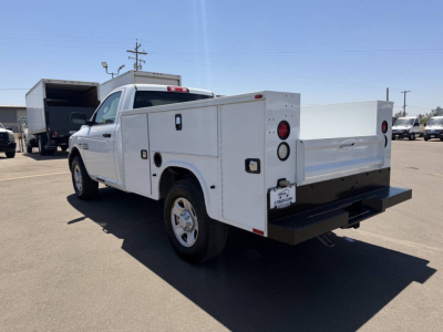 Ram 2500 service/body truck rear three-quarter view showing utility compartments and pickup bed with tail lights