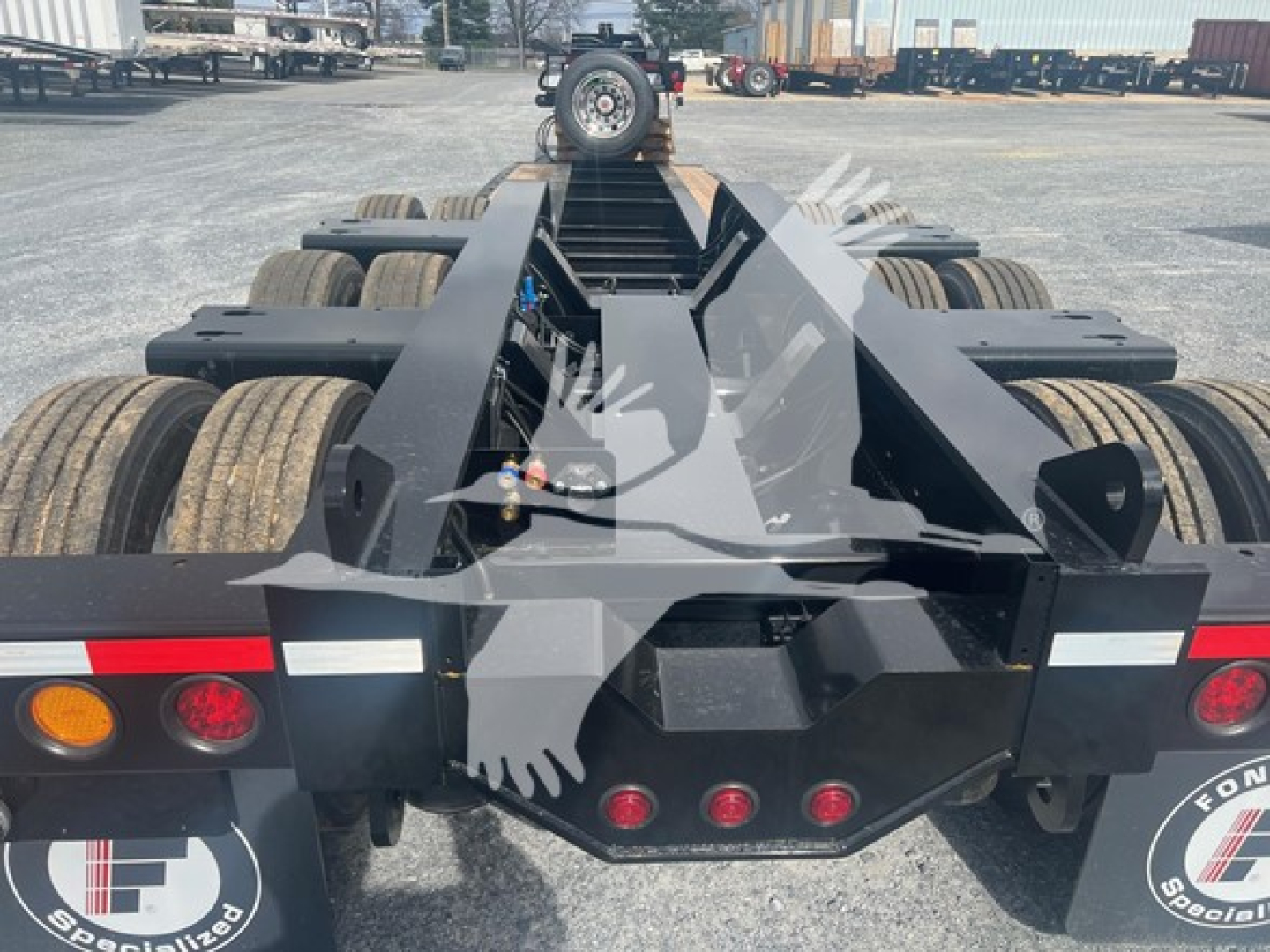 Trailer hitch area of a Fontaine 55H-Dsr lowboy trailer showing rear frame, multiple axles, and lighting. Visible text on sticker: none readable; VIN and stock numbers provided in listing.
