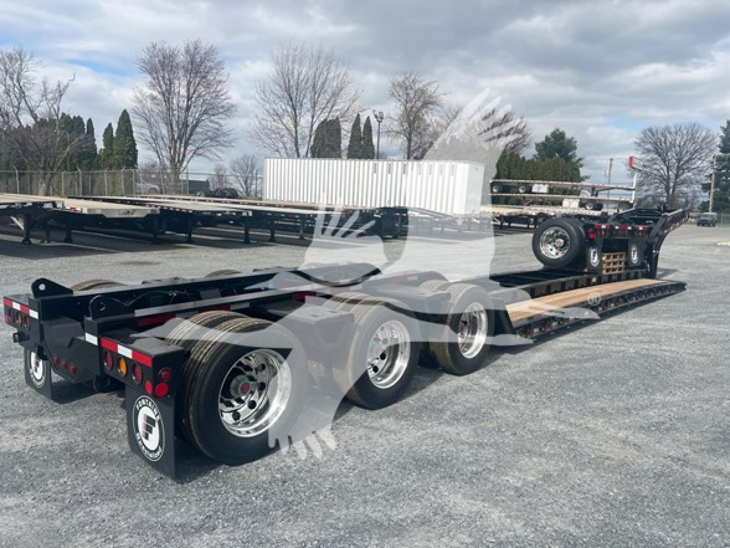 Lowboy trailer showing tandem rear axles and long flatbed with gooseneck; Fontaine 55H-Dsr model, VIN 13NE53301V35A7006, stock V35A7006.