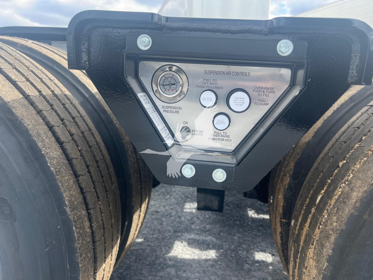 Fontaine Magnitude 55H-Dsr lowboy trailer coupler area with control panel and dual tires showing gauges and labels.