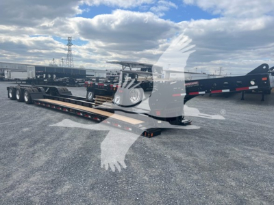 Fontaine 55H-Dsr lowboy trailer showing long flatbed with gooseneck and dual axles, in a gravel lot.