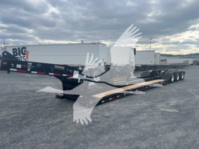 Lowboy trailer showing Fontaine 55H-DSR with long low deck and multiple axles, serial/sticker area not legible; exterior is light colored with black undercarriage.