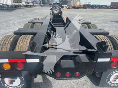 Trailer hitch area of a Fontaine 55H-Dsr lowboy trailer showing rear frame, multiple axles, and lighting. Visible text on sticker: none readable; VIN and stock numbers provided in listing.
