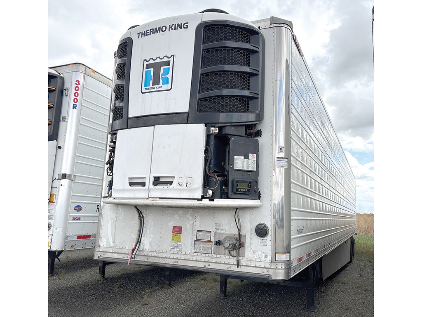 Reefer trailer with Thermo King unit on front, Everest series by Great Dane, silver exterior, rear visible wheels, VIN TW802595 and stock 547703.