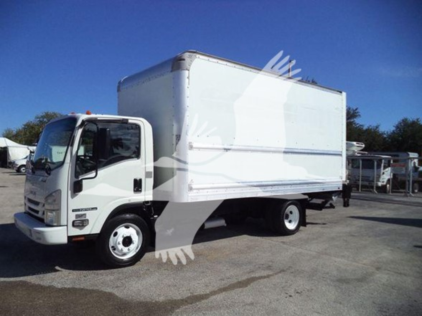 Isuzu NPR-HD box truck with white cab and box, side view. No visible text or labels on the vehicle itself.