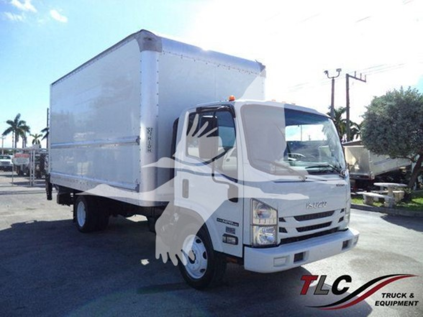 Isuzu NPR HD box truck showing cargo box and cab in a dealership lot.