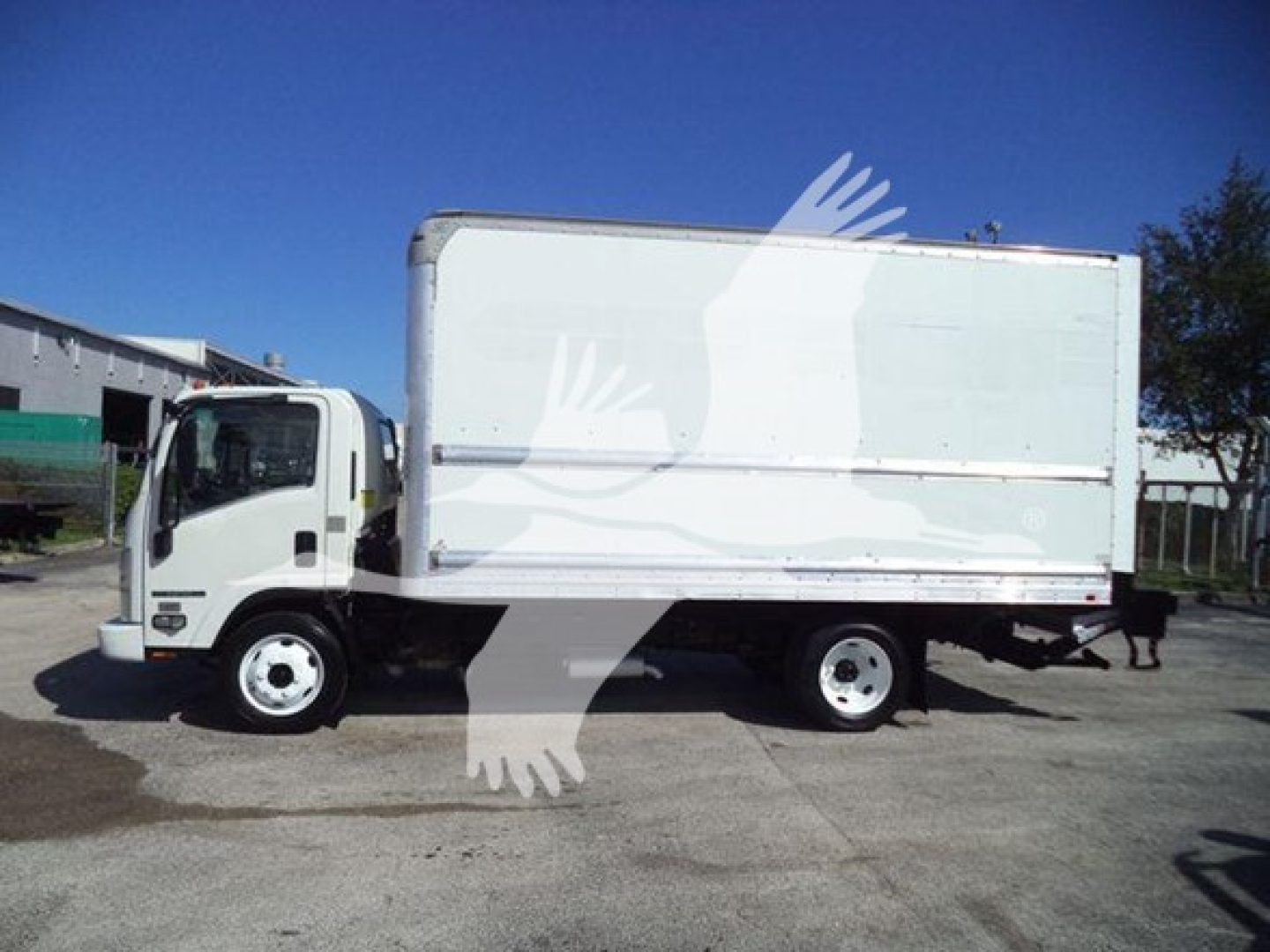 Isuzu NPR HD medium-duty box truck side view showing cab and box cargo area; no legible labels visible on the truck from distance.