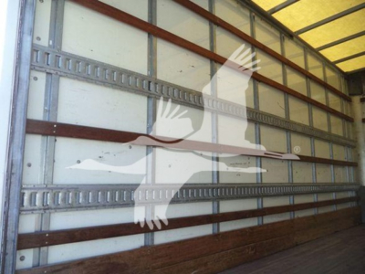 Isuzu NPR HD cargo box truck interior side wall with metal rails and wooden floor, stock image overlay watermark.