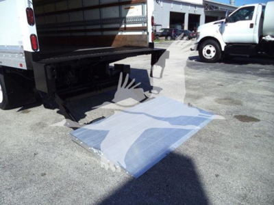 Isuzu NPR HD truck with hydraulic lift at rear showing loading ramp extended.