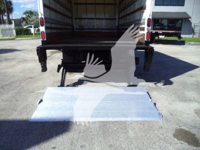 Isuzu NPR-HD box truck with lowered rear liftgate/ ramp showing open cargo area and platform at rear.