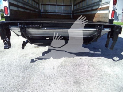 Isuzu NPR HD truck rear showing cargo bed and hydraulic tailgate in-service