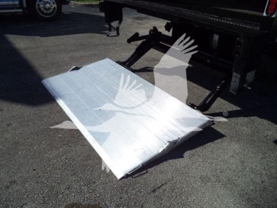 Isuzu NPR HD truck bed ramp/step plate showing aluminum surface with braces and mounting points