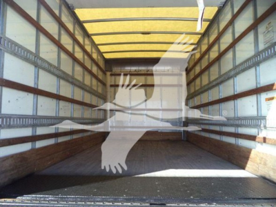 Isuzu NPR HD truck cargo area empty with wooden side rails and a large translucent graphic overlay of two hands joining in center, interior yellow roof panels.