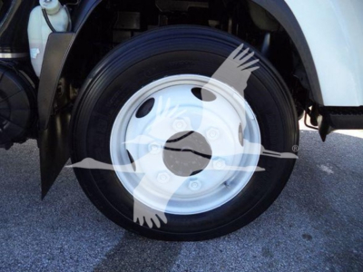 Isuzu NPR HD wheel/tendered front wheel and fender area showing wheel rim and tire