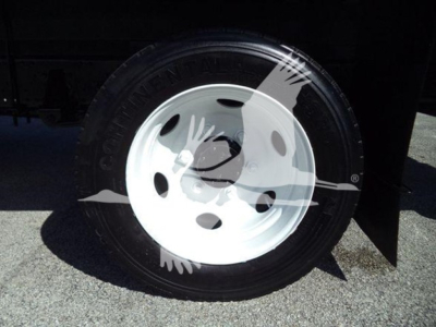 Isuzu NPR HD wheel/rim close-up showing white steel wheel and tire mounted on front axle.