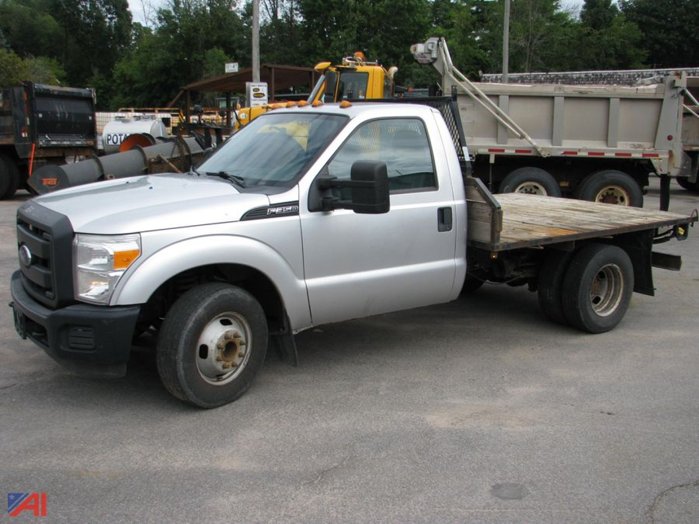 Flatbed tow truck side view showing Ford F-350 Super Duty label and dual rear wheel configuration.