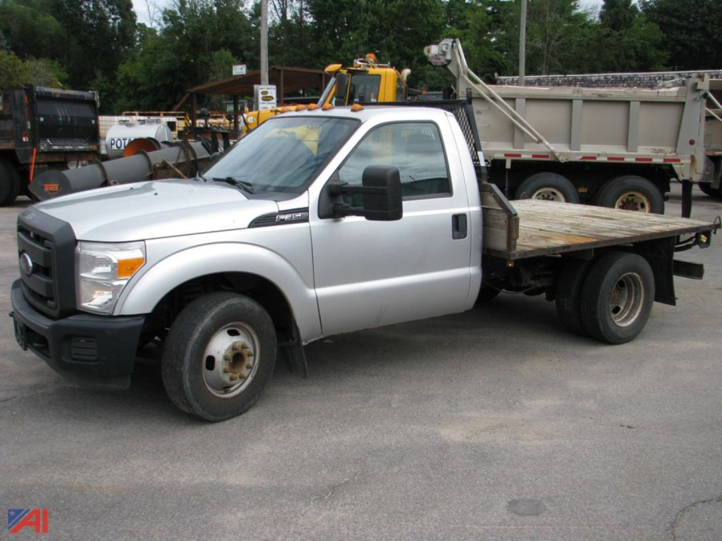 Flatbed tow truck side view showing Ford F-350 Super Duty label and dual rear wheel configuration.