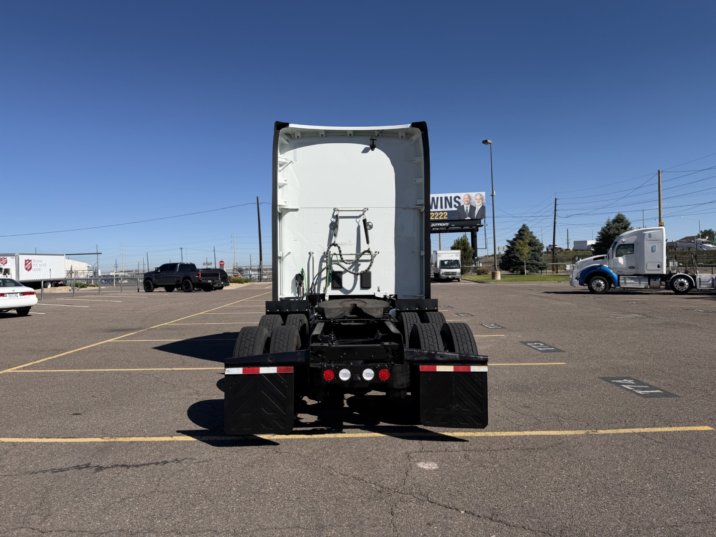 Kenworth T680 tractor rear view showing fifth wheel area and rear tires with license plate area void.