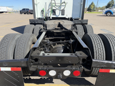 KENWORTH T680 rear view showing dual rear axles with suspension and frame, spare parts, and connectors.