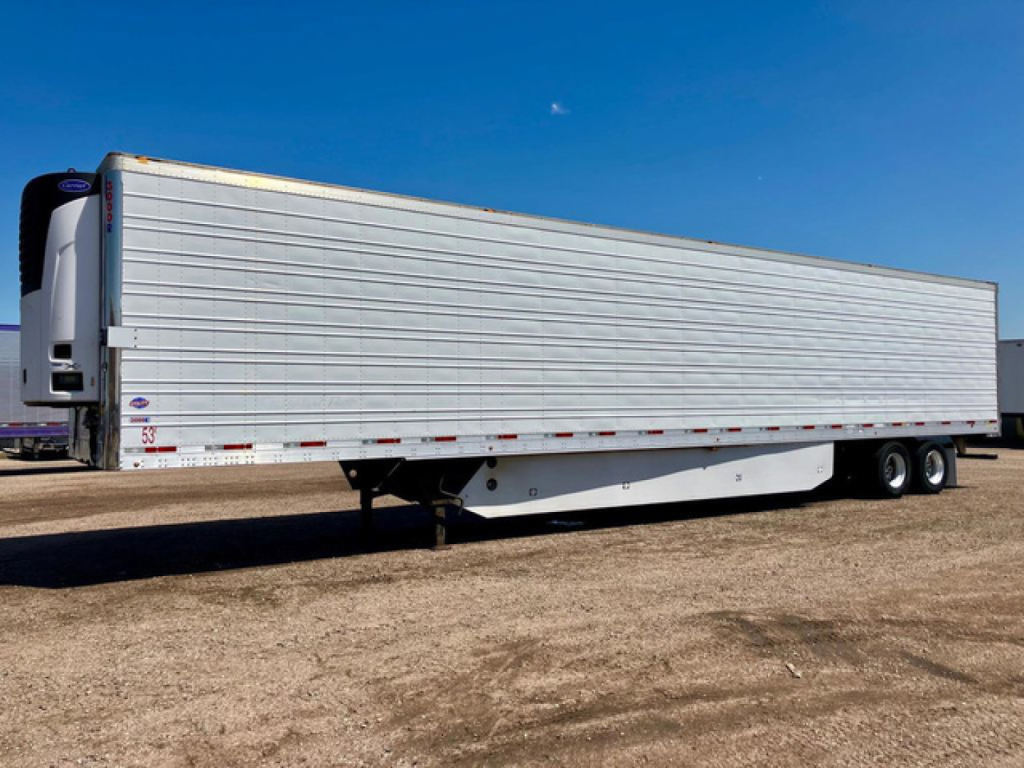 Trailer side view of a refrigerated 2017 Utility Reefer trailer with silver exterior and white refrigeration unit at the front.