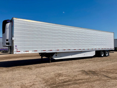 Trailer side view of a refrigerated 2017 Utility Reefer trailer with silver exterior and white refrigeration unit at the front.
