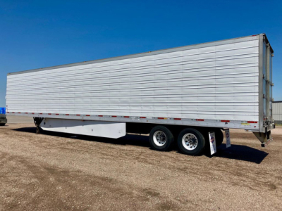 Trailer side view showing a 2017 Utility refrigerated trailer with metal siding and dual rear axles.