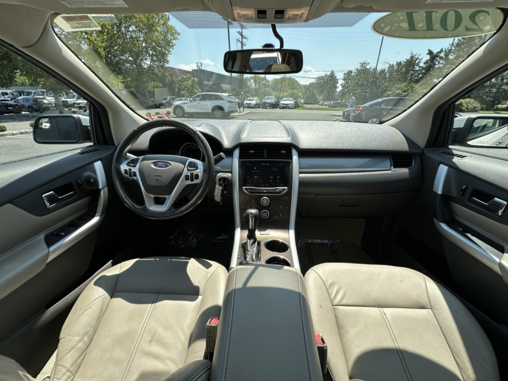 Ford Edge interior view showing dashboard, steering wheel, center console, and front seats.