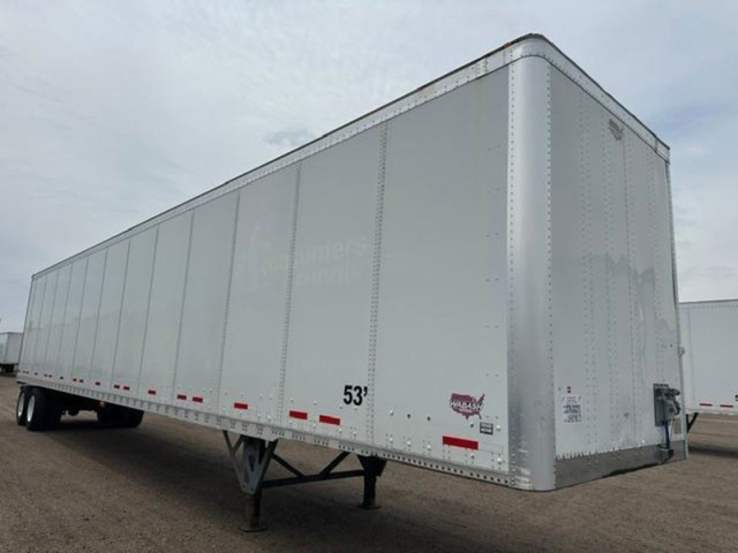 Trailer image showing a white 53' Wabash van trailer with front hitch, side vertical riveted panels, and landing gear visible.