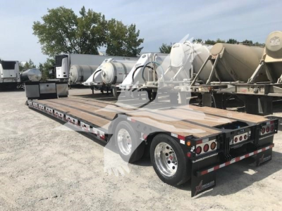 XL Specialized XL80Mfga lowboy trailer with flatbed and dual rear axles, stock number TL025070, VIN 4U3J05322TL025070, carrying large tanks and equipment.