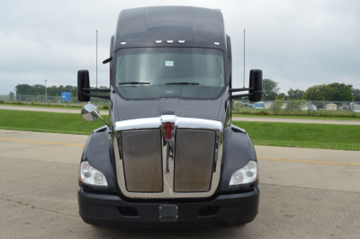 Front view of a 2019 Kenworth T680 truck with large chrome grille and black bumper. No visible text labels legible on image.