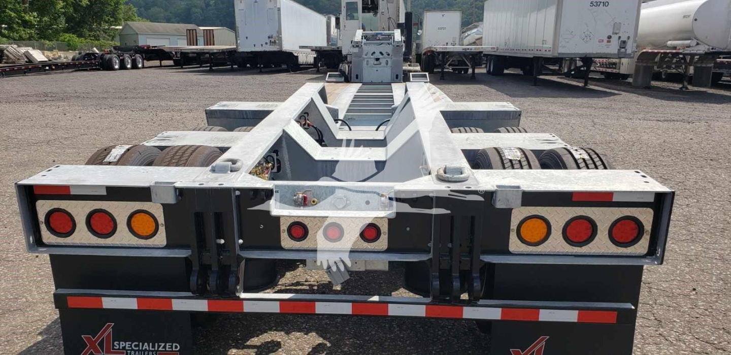 Trailer rear view showing LDH lowboy with taillights and hitch area and branding 'XL SPECIALIZED' on plate.