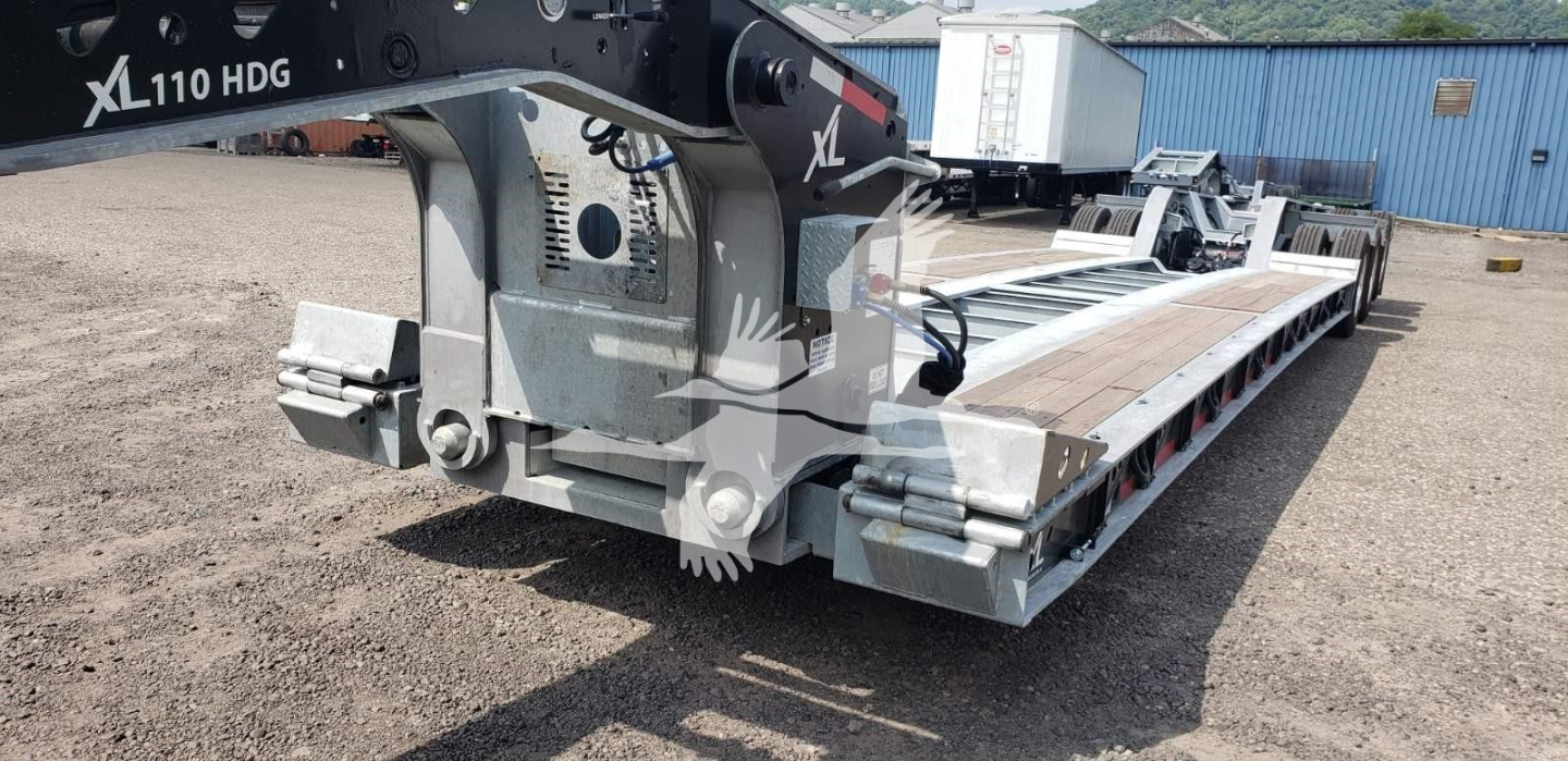 Trailer deck of XL Specialized 15" LDH lowboy showing wheel set and deck with metal beams and support structure.
