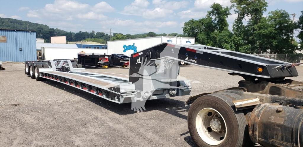 XL Specialized 15" LDH lowboy trailer showing long multi-axle deck and gooseneck area; side rails and tandem axles visible.