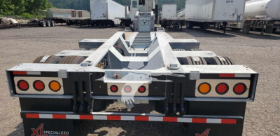 Trailer rear view showing LDH lowboy with taillights and hitch area and branding 'XL SPECIALIZED' on plate.