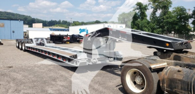 Trailer showing lowboy with 55-ton capacity and 15 inch LDH galvanized beams, new XL Specialized trailer in outdoor lot.