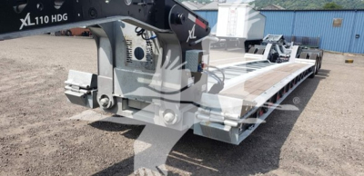 Lowboy trailer deck with 55-ton XL hydraulic gantry legs and 15-inch LDH galvanized frame, front jack and wheel set visible.