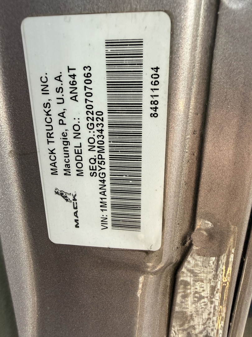 Trucks MACK label on door jam showing VIN and model info. Text includes MACK TRUCKS, INC., Mt. A., USA, TRUCKS INC. Labeled MACK, Model AN64T, VIN 1M1AN4GY5PM034320, DE 5? etc, Barcode numbers 84811604.
