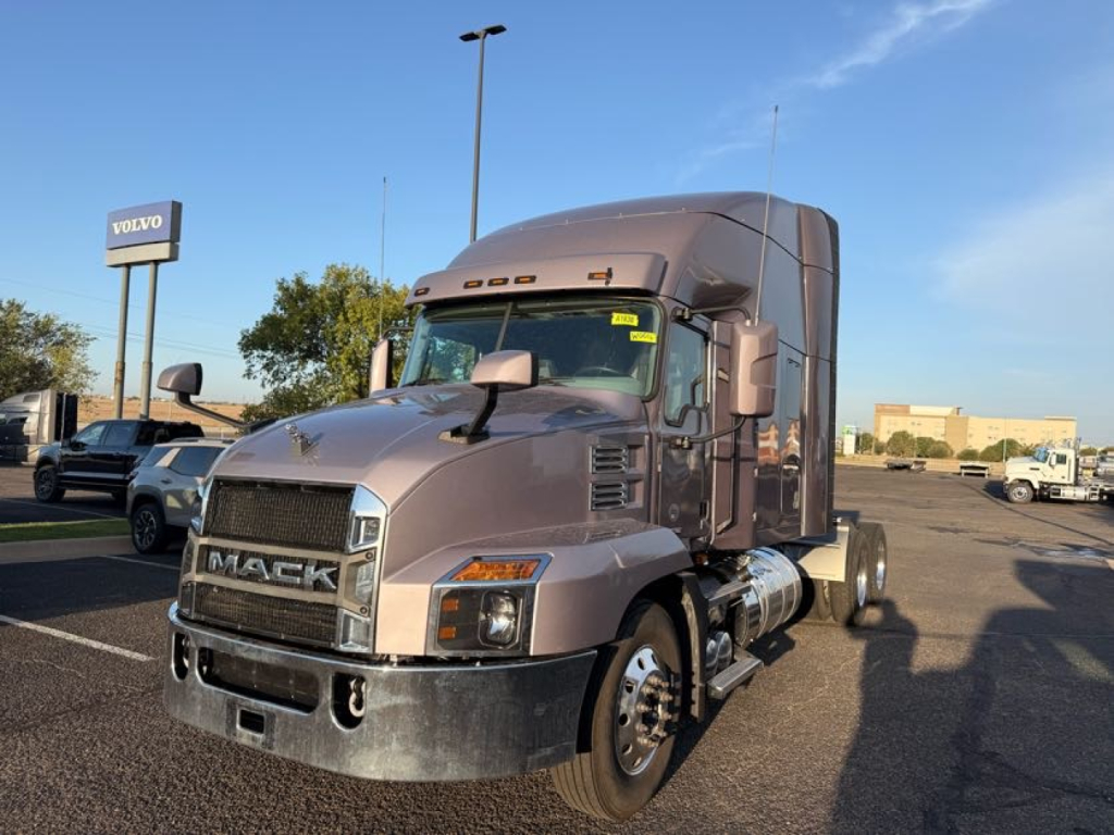 Mack AN64T70 conventional sleeper truck in lot showing front grille and cab; VIN sticker not legible; stock W0016; used vehicle.