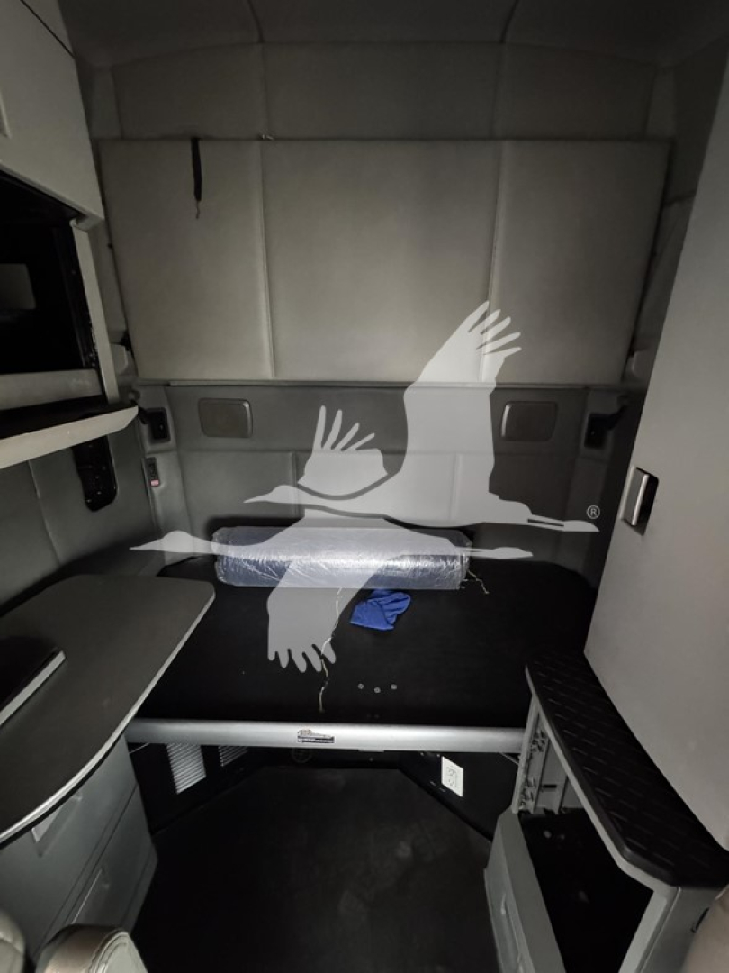 Kenworth T680 sleeper cab interior showing cargo area with sleeping berth and side panels.